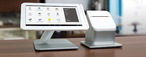 Server using touchscreen restaurant POS with color-coded menu tiles